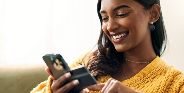 Happy, woman and phone for online shopping with credit card information, fintech website and digital payment in lounge. Smile, female person and e commerce, retail discount and banking app at house.